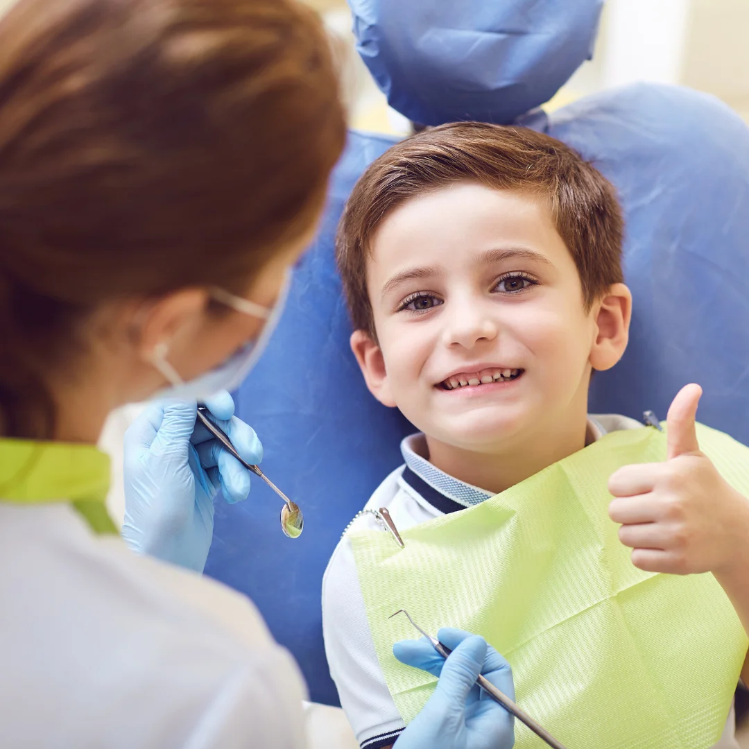 Child smiling during a gentle pediatric dental visit at Glendale Dental Wellness